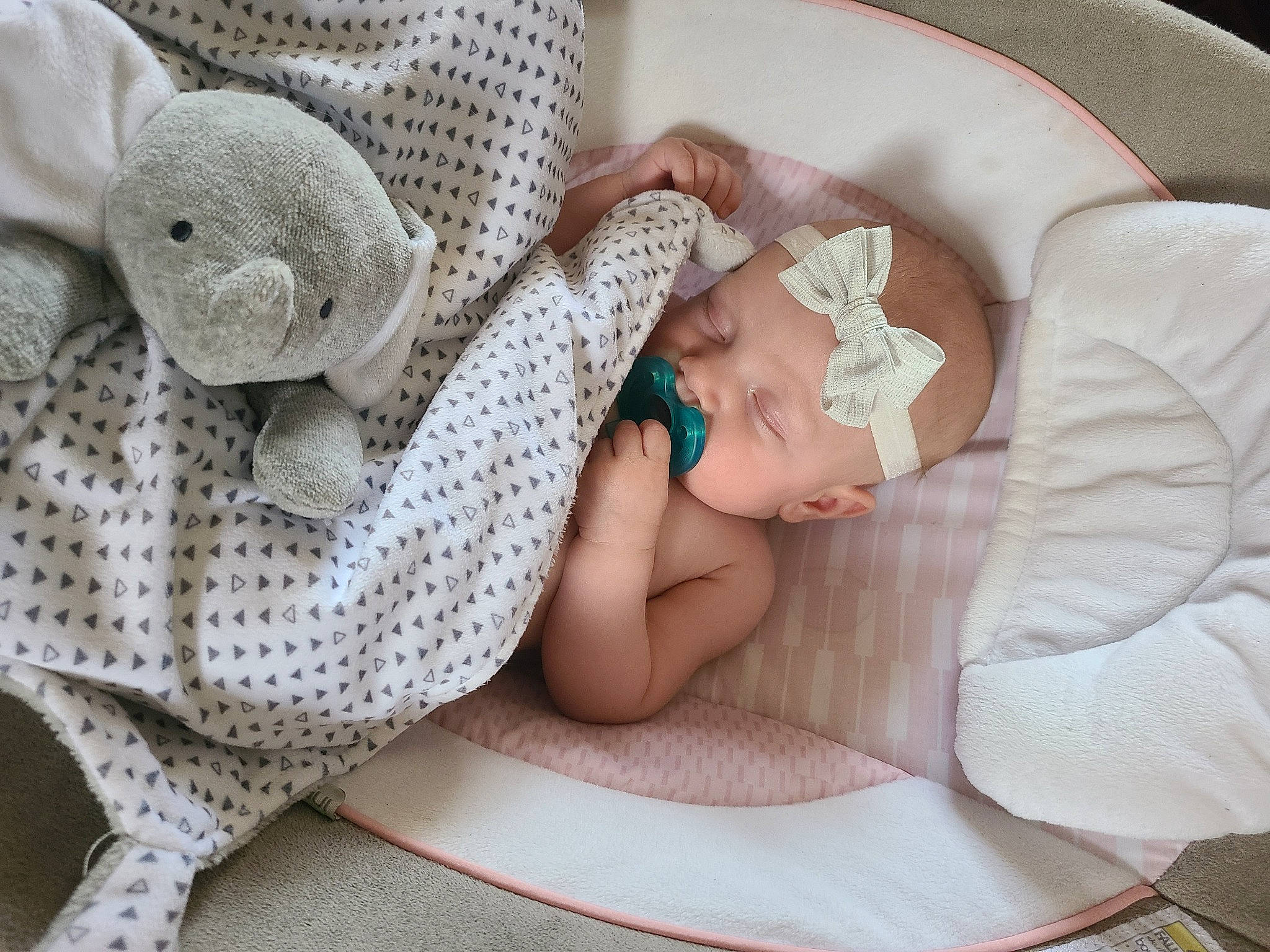 Ember is registered to the contest to win money with this photo: art, baby, baby_products, baby_sleeping, baby_toddler_clothing, bedding, child, comfort, craft, fashion_accessory, headgear, linens, pattern, person, product, room, sitting, textile, toddler, wood