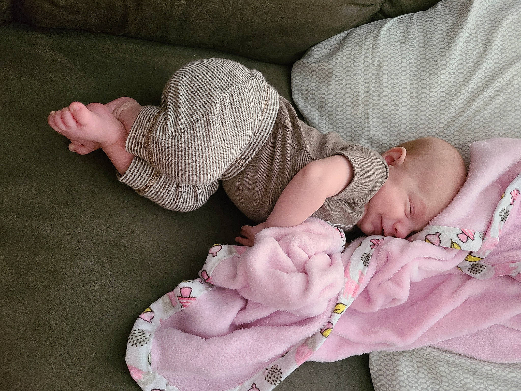 Ember is registered to the contest to win money with this photo: arm, baby, baby_products, baby_sleeping, baby_toddler_clothing, comfort, finger, hand, human_body, human_leg, leg, linens, nail, person, pink, skin, sleeve, sock, textile, thigh