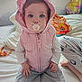 Aria participe au concours pour gagner de l'argent avec cette photo : baby, child, pacifier, hood, pink, vest, gray_pants, bed, blanket, pajamas, person, indoor, window, cute, sitting, clothing, face, blue_eyes, hand, soft_lighting