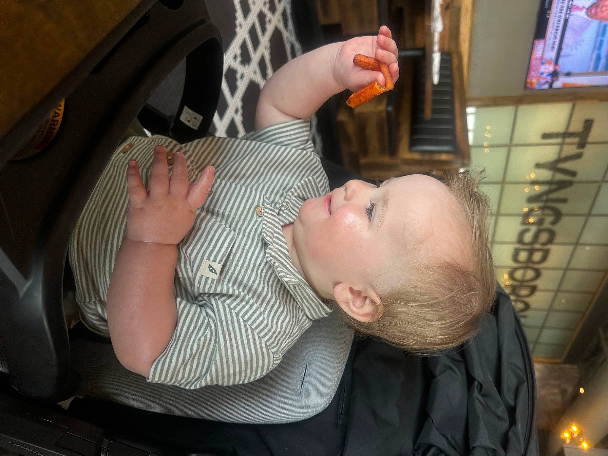 Adonis is registered to the contest to win money with this photo: auto_part, baby, baby_carriage, baby_products, baby_toddler_clothing, car_seat, chair, child, comfort, ear, eyelash, fun, gesture, hand, mammal, person, picture_frame, sitting, television, thumb