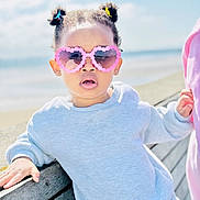 Diamond joined the competition — help win amazing prizes! toddler, child, sunglasses, heart_shaped, pink, hair_clips, beach, bench, outdoor, sunny, blue_sky, casual_clothing, sweatshirt, portrait, person, fashion, cute, young_child, daylight, relaxed