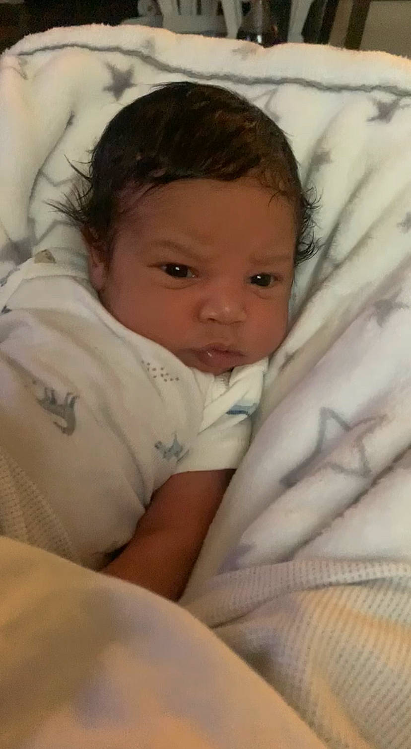 Azariah joined the competition — help win amazing prizes! baby, cheek, child, chin, comfort, elbow, eye, eyebrow, eyelash, fur, happy, head, iris, linens, lip, mouth, nose, person, sitting, skin