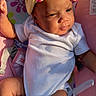 Anari is registered to the contest to win money with this photo: baby, infant, headband, yellow_bow, white_onesie, sitting, colorful_seat, floral_pattern, comb, sunlight, cute, child, indoors, soft_lighting, happy, portrait, baby_accessories, clothing, baby_sock, relaxed