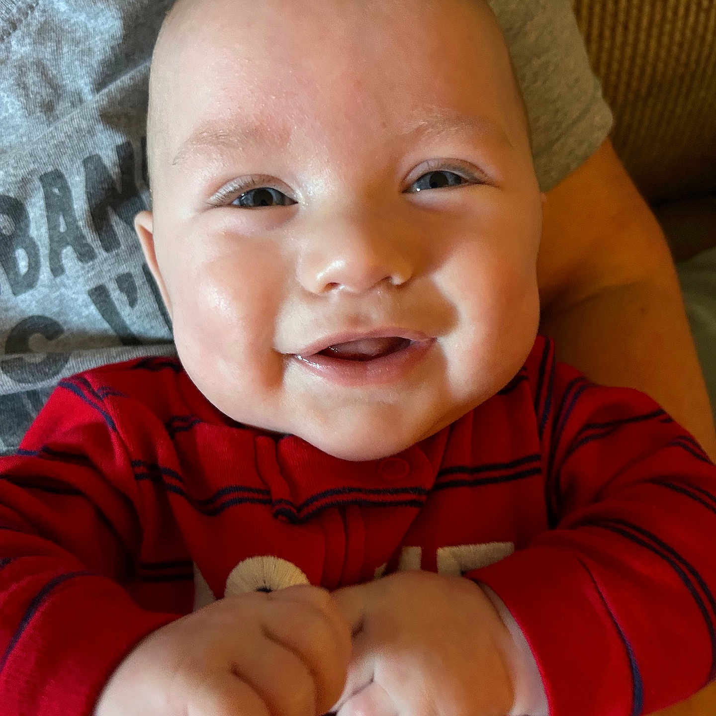 Grant is registered to the contest to win money with this photo: accessories, baby, bodypart, bracelet, couch, cutlery, face, finger, furniture, hand, happy, head, jewelry, laughing, newborn, person, photography, portrait, sitting, smile