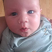 Jafhet Leon is registered to the contest to win money with this photo: baby, infant, face, blue_eyes, clothing, shirt, skin, expression, hand, arm, person, portrait, cute, newborn, young_child, indoors, closeup, apparel, babywear, curious