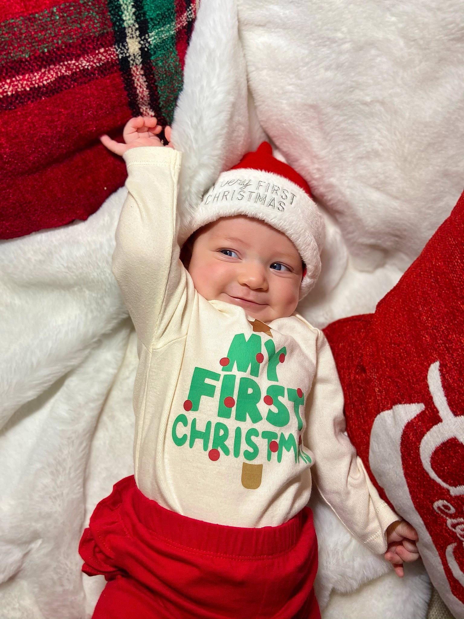 Demi joined the competition — help win amazing prizes! baby, baby_toddler_clothing, cap, child, christmas, comfort, event, face, happy, headwear, holiday, human_body, linens, outerwear, person, red, santa_claus, sleeve, t_shirt, textile