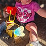 Melissa joined the competition — help win amazing prizes! toddler, child, outdoor, play, bucket, bee_planter, pink_shirt, barbie, sneakers, sand, sunlight, shadow, curly_hair, toy, garden, legs, person, casual_clothing, nature, daylight
