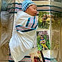 Legend is registered to the contest to win money with this photo: adult, baby, bed, blanket, clothing, face, female, footwear, furniture, girl, hat, head, newborn, person, photography, portrait, shoe, shorts, teen, woman