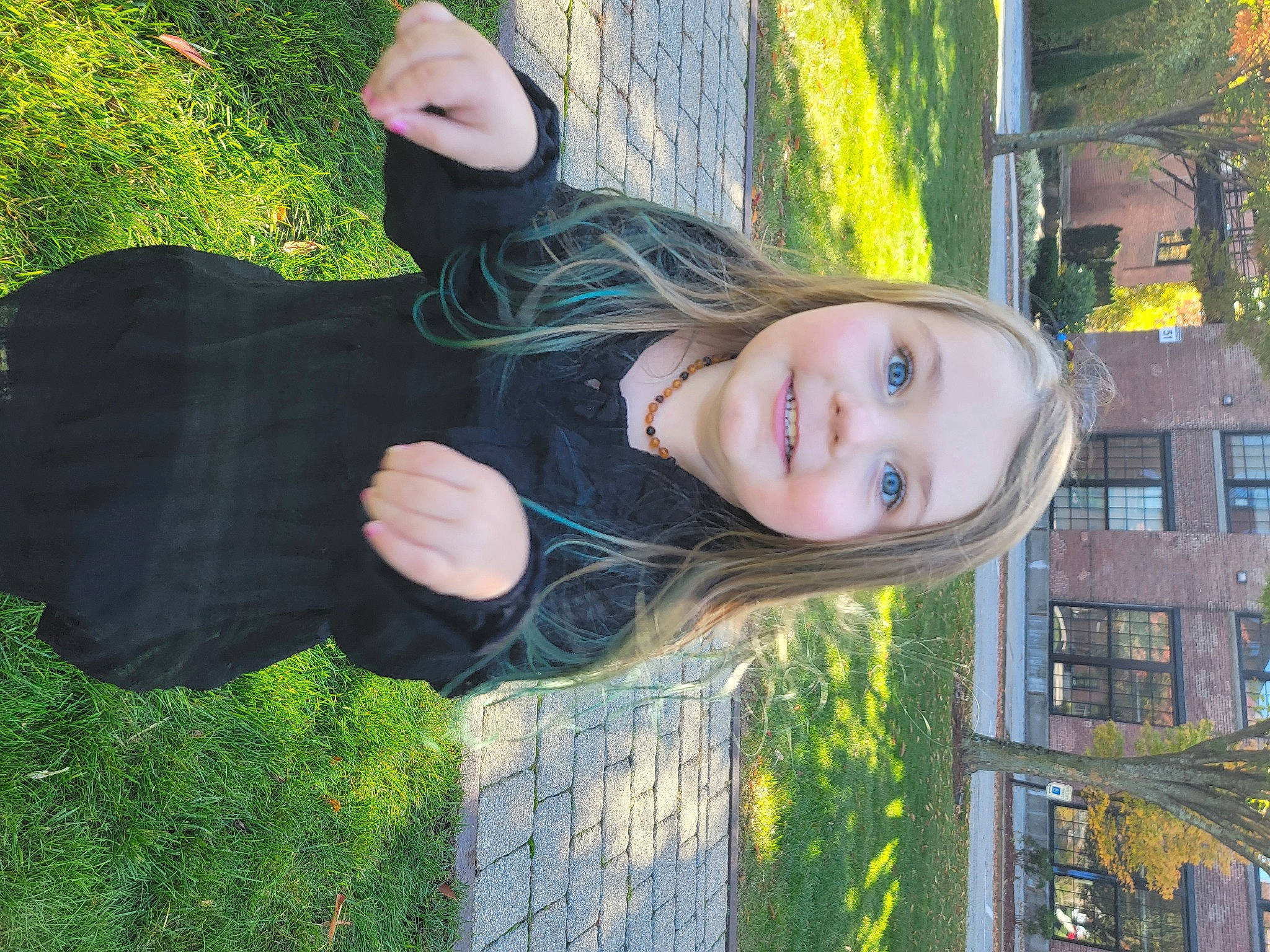 Makenna is registered to the contest to win money with this photo: child, cool, eye, facial_expression, fun, gesture, grass, happy, head, joy, laugh, leisure, lip, people_in_nature, person, plant, sitting, smile, tree, window