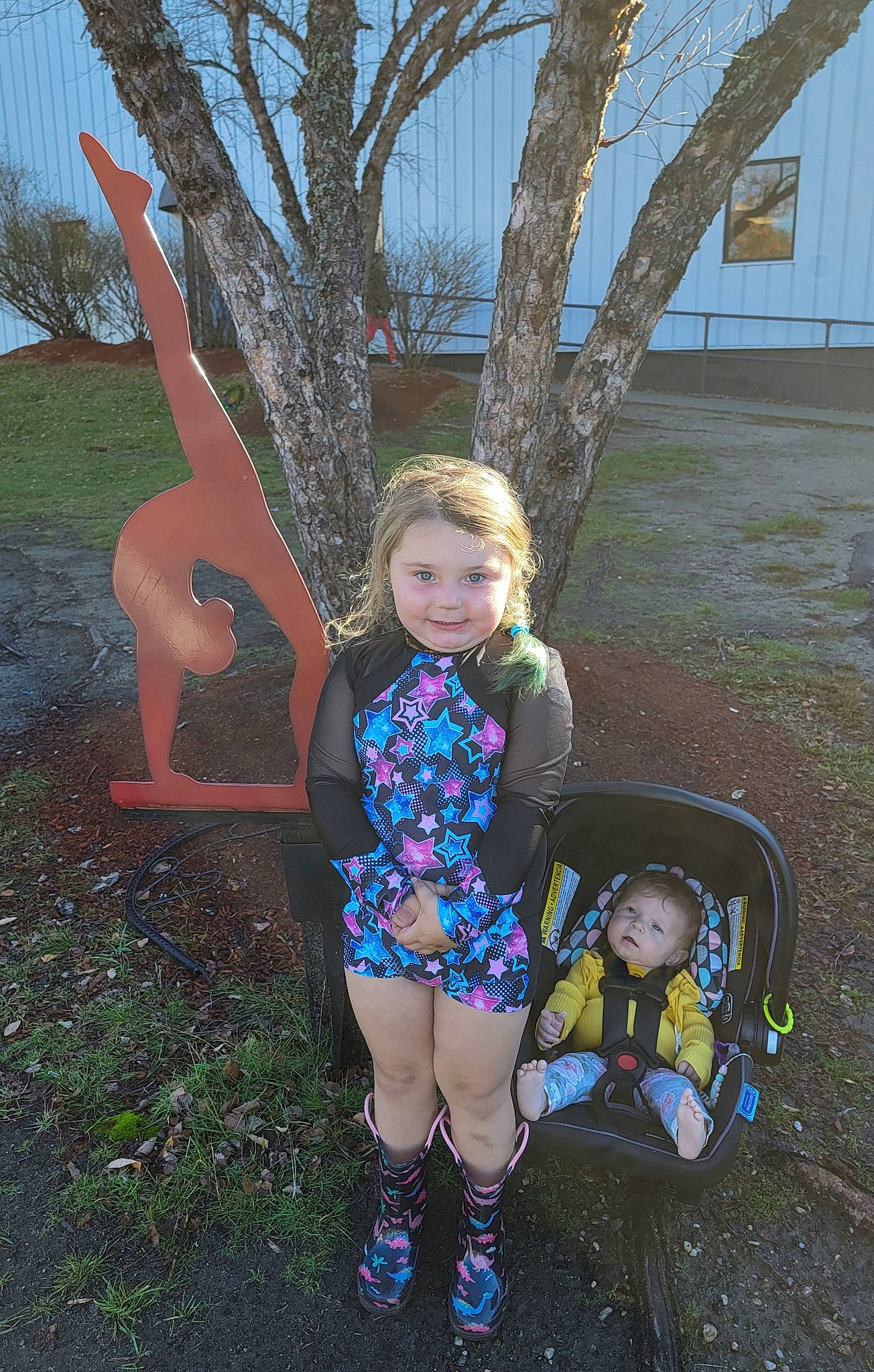 Makenna is registered to the contest to win money with this photo: baby, baby_toddler_clothing, electric_blue, fun, gesture, grass, happy, human_leg, joy, leisure, magenta, pattern, people_in_nature, person, plant, play, recreation, sandal, sitting, thigh