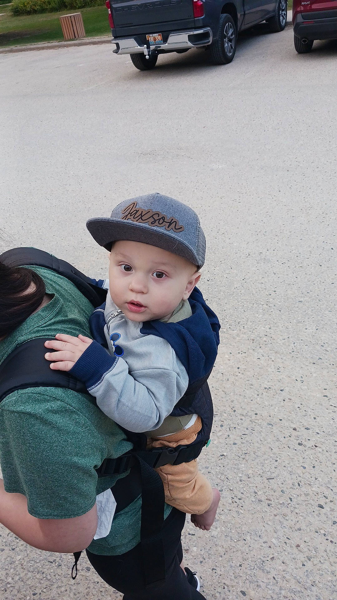 Jaxson joined the competition — help win amazing prizes! asphalt, automotive_tire, baby, baseball_cap, bumper, cap, child, family_car, fashion_accessory, freezing, gesture, grass, headgear, headwear, landscape, motor_vehicle, person, road, road_surface, sitting