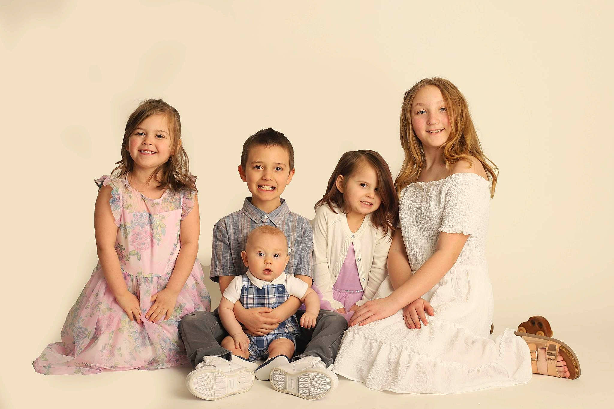 Mariah is registered to the contest to win money with this photo: baby, baby_toddler_clothing, child, comfort, dress, event, face, flash_photography, formal_wear, fun, gesture, hairstyle, happy, joy, person, portrait_photography, sitting, skin, smile, standing