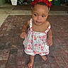 Zelilah is registered to the contest to win money with this photo: toddler, child, birthday, headband, dress, barefoot, indoor, brick_floor, party, celebration, curious, smiling, person, young_child, colorful, festive, decorations, cute, floor, standing