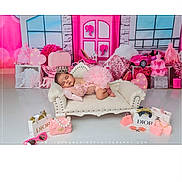 Vihana is registered to the contest to win money with this photo: baby, sleeping, sofa, pink, crown, toy, miniature, designer_bags, decor, background, cute, child, portrait, indoor, soft_lighting, fashion, playful, resting, props, photography