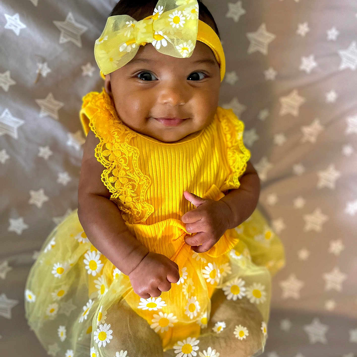 Azula is registered to the contest to win money with this photo: accessories, baby, bodypart, cap, clothing, dress, face, finger, flower, formalwear, hand, happy, hat, head, person, photography, plant, portrait, sitting, smile