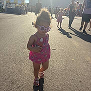 Celine joined the competition — help win amazing prizes! child, toddler, sunglasses, curly_hair, pink_clothing, sandal, bottle, shadow, outdoor, sunlight, people, fairground, tent, asphalt, summer, daytime, walking, family, casual, crowd
