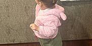 Celine joined the competition — help win amazing prizes! toddler, child, indoor, floor, wooden_floor, couch, blanket, hairclip, pink_jacket, green_skirt, white_tights, shoes, standing, person, furniture, home, cozy, cute, looking_sideways, young_child