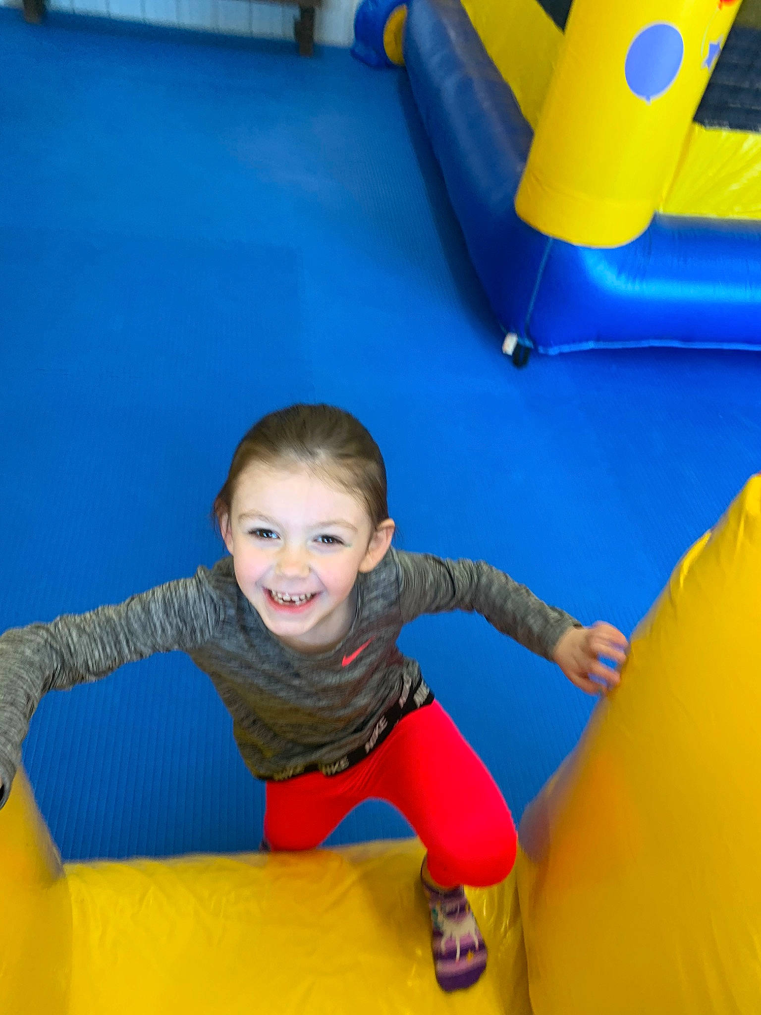 Kinsleigh is registered to the contest to win money with this photo: baby_toys, blue, bounce_house, child, fun, games, human_settlement, inflatable, joy, leisure, outdoor_play_equipment, person, play, playground, public_space, recreation, toddler, yellow