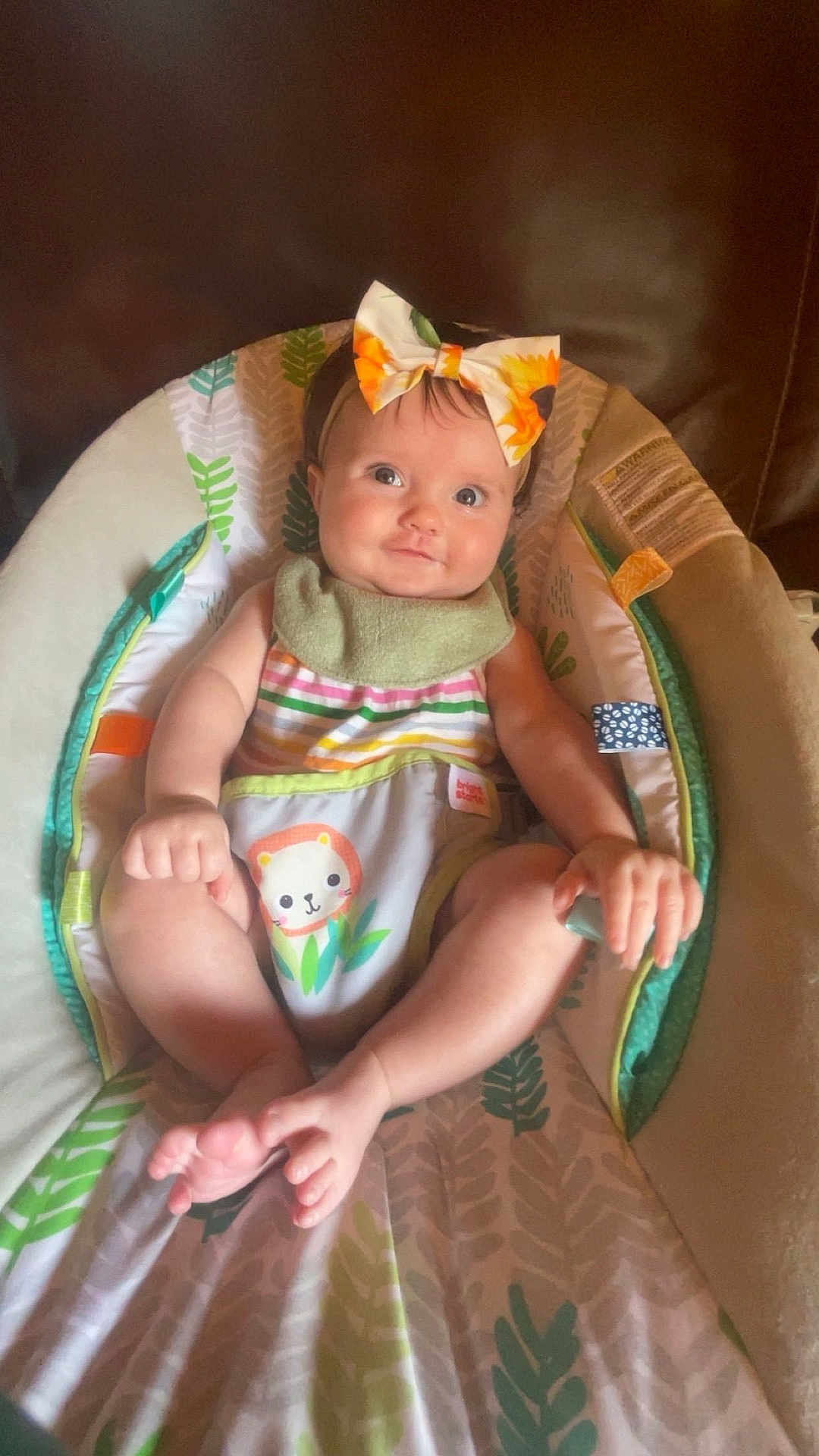 Addison is registered to the contest to win money with this photo: baby, infant, child, headband, bow, striped_clothing, animal_print, baby_seat, leaf_pattern, colorful, happy, cute, smiling, indoors, soft_lighting, skin, legs, feet, hands, portrait