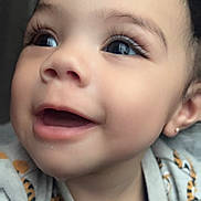 Kiari Bennett joined the competition — help win amazing prizes! baby, close_up, smiling, happy, face, eyes, eyelashes, mouth, cheeks, clothing, patterned_clothing, earring, curly_hair, infant, cute, portrait, child, indoor, soft_light, joy