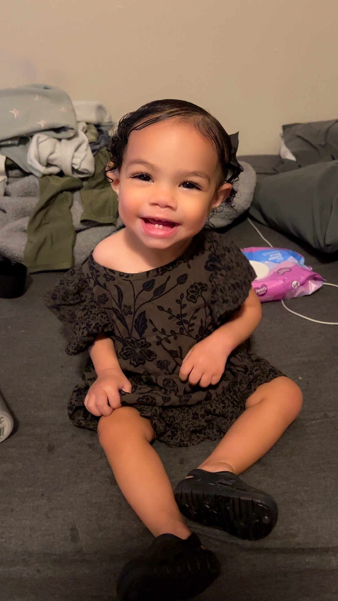 Kiari Bennett joined the competition — help win amazing prizes! child, toddler, smiling, sitting, indoor, curly_hair, black_shoes, dress, happy, face, person, blanket, couch, clothing, home, cute, young_child, small_hands, black_hair, cheerful