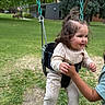 Itzayana joined the competition — help win amazing prizes! activity, building, casual, child, clothing, daytime, fun, grass, hand, happy, nature, outdoor, park, person, playground, smile, swing, toddler, trees, young_child