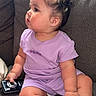 adidas, baby, barefoot, camera, casual, child, chubby, couch, curly_hair, cute, earrings, furniture, gray_couch, indoor, person, purple_clothing, side_profile, sitting, sunlight, toddler