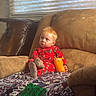 toddler, child, pajamas, sippy_cup, blanket, couch, window, blinds, toy, indoor, daylight, face, hair, furniture, relaxing, cozy, home, person, comfort, casual