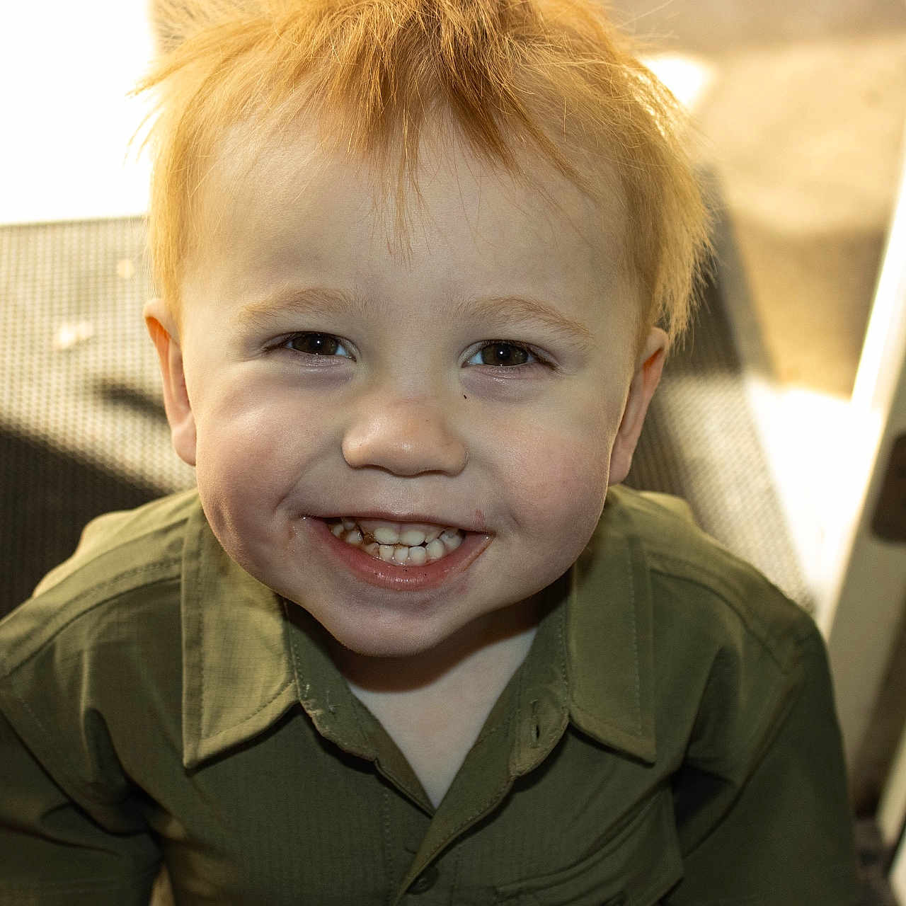 Carter joined the competition — help win amazing prizes! child, smiling, blonde_hair, green_shirt, indoors, door, sunlight, shadow, happy, face, portrait, young_boy, cute, teeth, eyes, casual_clothing, standing, home, expression, person