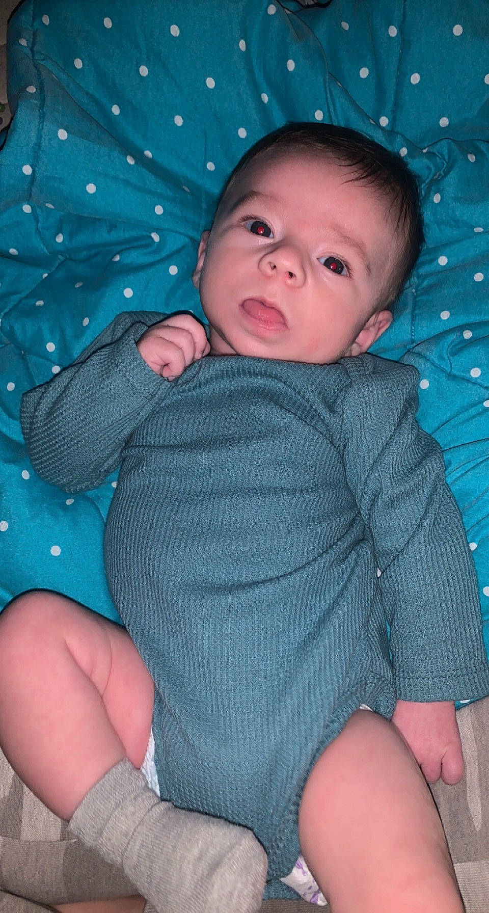 Paxton is registered to the contest to win money with this photo: aqua, azure, baby, baby_toddler_clothing, blue, cheek, child, comfort, eye, finger, head, human_body, organ, pattern, person, pink, skin, sleeve, textile, thigh