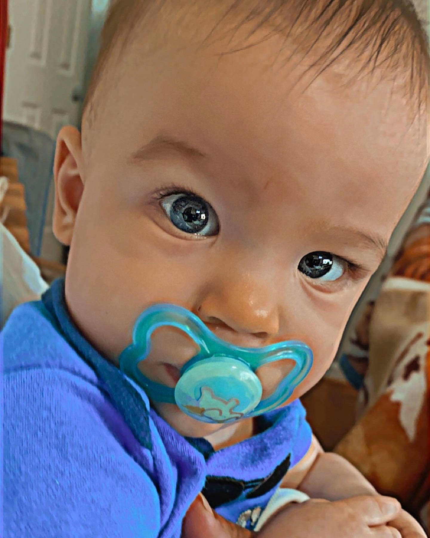 Xander is registered to the contest to win money with this photo: azure, baby, baby_toddler_clothing, cheek, child, drinkware, ear, eyelash, facial_expression, finger, hairstyle, happy, iris, lip, mouth, nose, person, product, skin, tableware