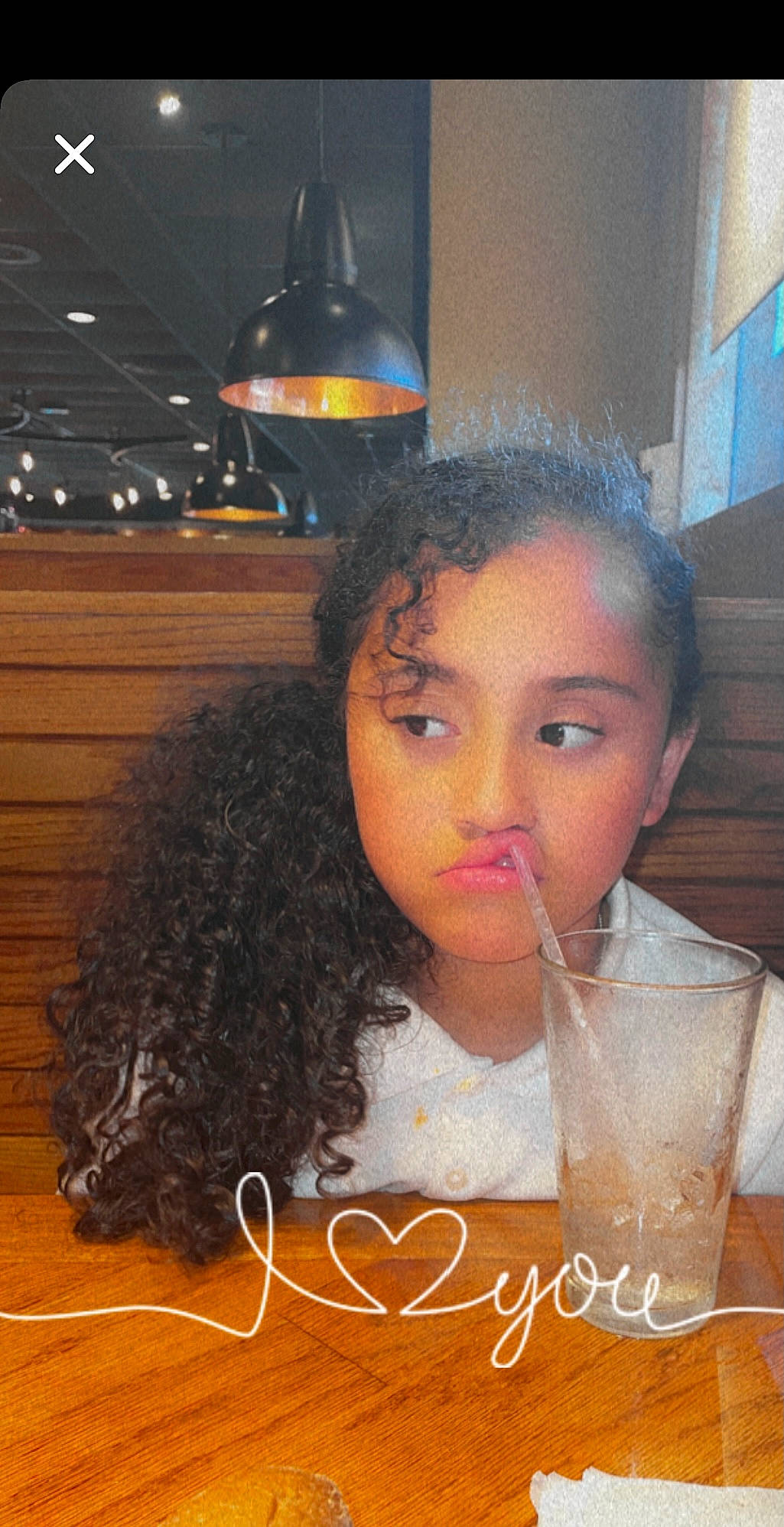 Morgan is registered to the contest to win money with this photo: black_hair, brown_hair, cheek, child, cocktail, drink, drinking, drinking_straw, drinkware, ear, eyebrow, eyelash, hair, happy, lace_wig, lip, long_hair, nose, person, ringlet