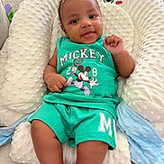 Fodé participe au concours pour gagner de l'argent avec cette photo : baby, child, cushion, cute, furniture, green_clothing, happy, home, indoor, infant, mickey_mouse, person, pillow, portrait, shirt, shorts, sitting, smile, soft_texture, toddler