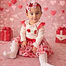Eden is registered to the contest to win money with this photo: toddler, child, baby, pink, red, heart, bow, headband, dress, socks, gift_box, valentines_day, cute, sitting, portrait, indoor, decoration, holiday, celebration, smile