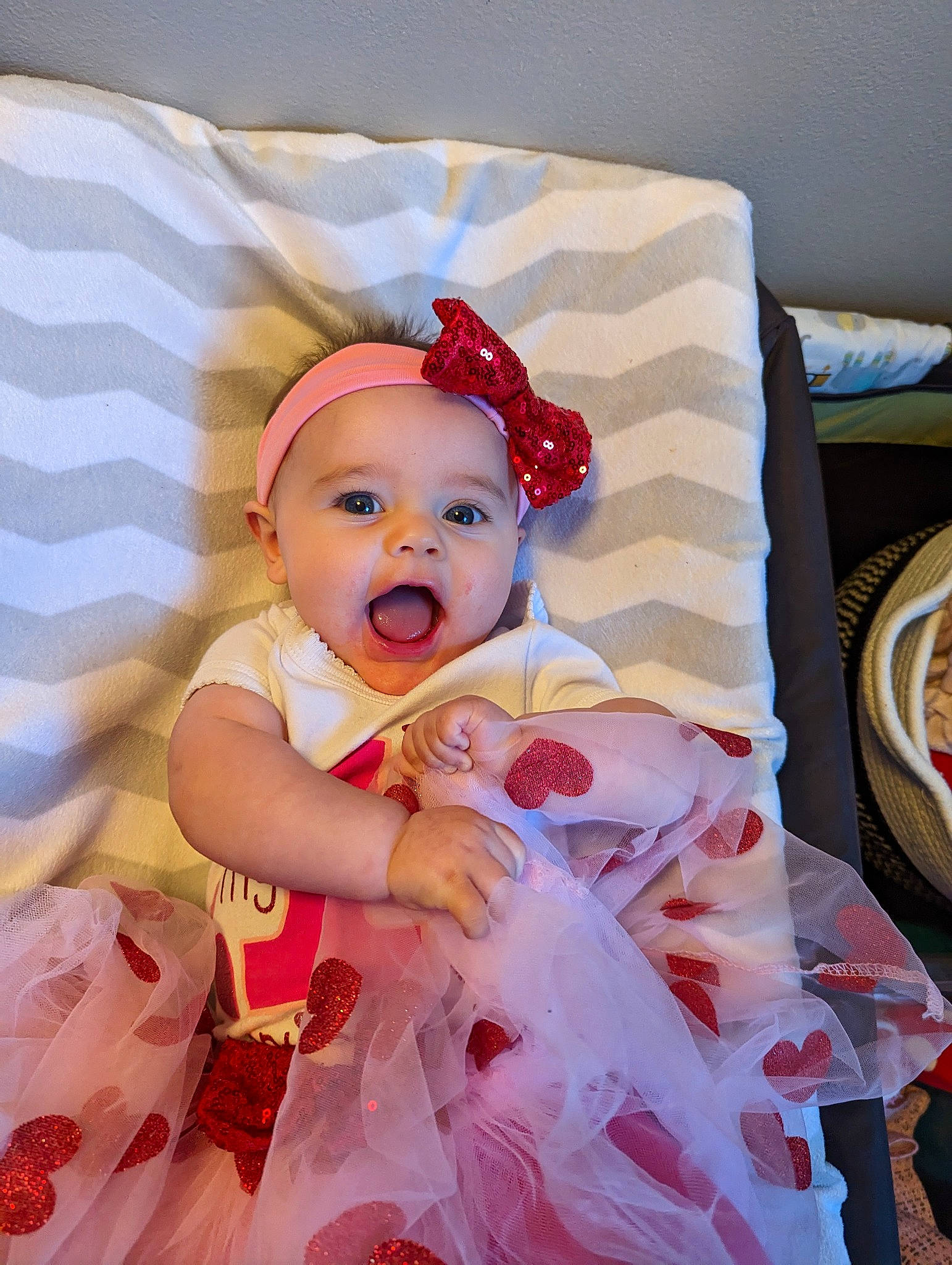 Elle is registered to the contest to win money with this photo: baby, baby_products, baby_toddler_clothing, child, costume, costume_hat, event, fashion_accessory, happy, hat, headband, headpiece, headwear, linens, magenta, pattern, peach, person, pink, platter