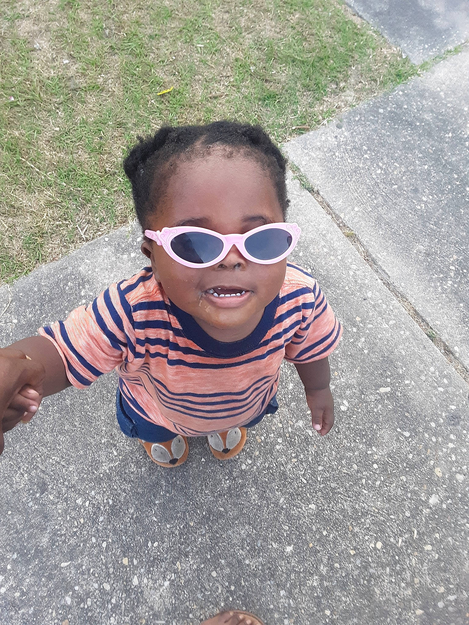 Dwayne is registered to the contest to win money with this photo: asphalt, child, cool, eyewear, face, fun, glasses, goggles, grass, head, leisure, person, personal_protective_equipment, photography, plant, smile, summer, sunglasses, toddler, vacation