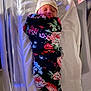 newborn, baby, swaddled, blanket, floral, hat, sleeping, hospital_bed, white, infant, peaceful, sleep, cozy, child, portrait, person, wrapped, indoors, soft_lighting, resting