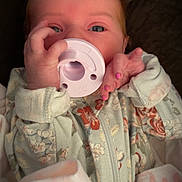 Haylo joined the competition — help win amazing prizes! baby, infant, pacifier, hand, pink_nail_polish, onesie, floral_pattern, face, eyes, clothing, sleepwear, cute, child, newborn, soft_lighting, portrait, indoors, fabric, fingers, nail_polish