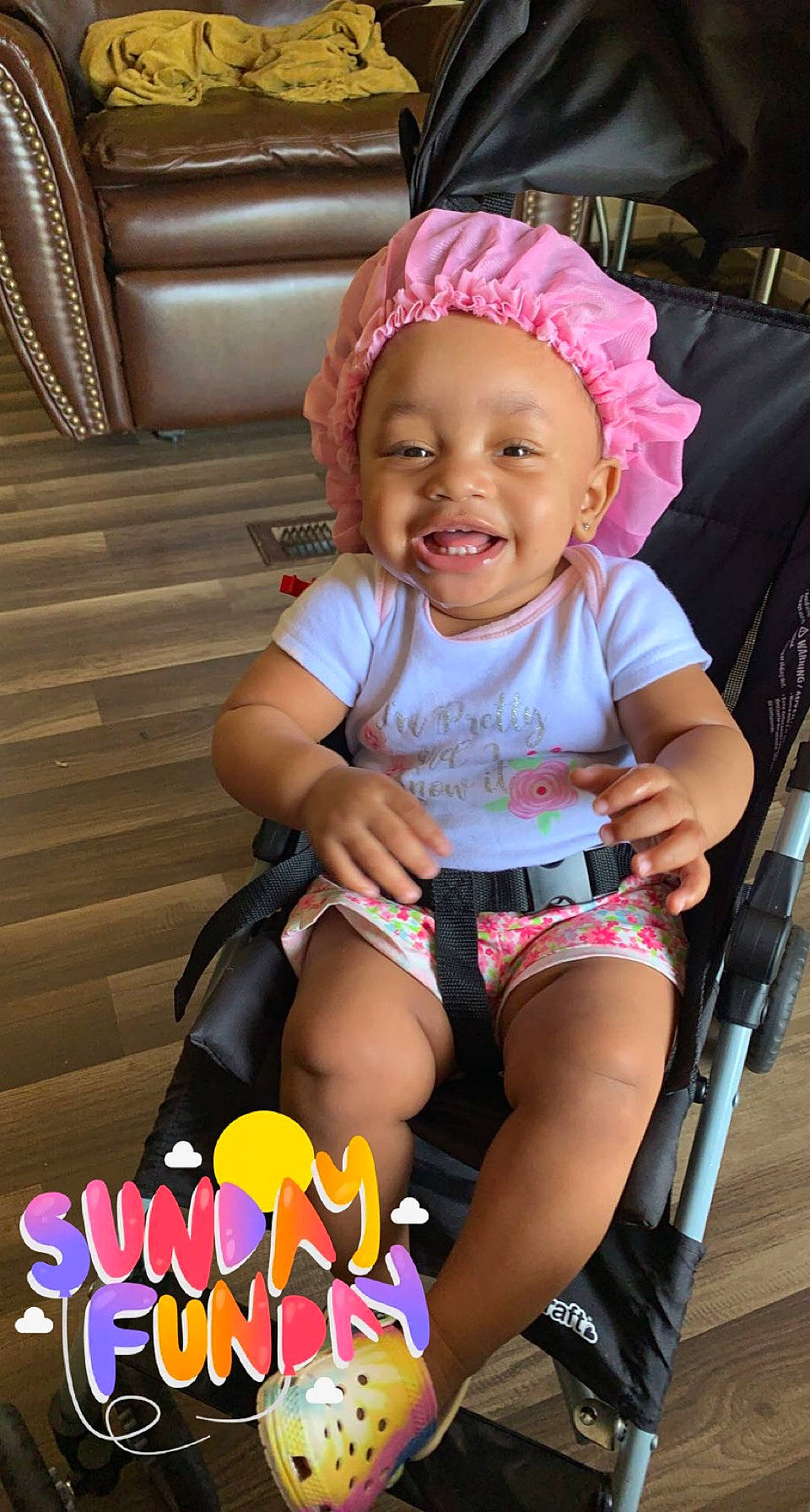 Annika joined the competition — help win amazing prizes! baby, baby_carriage, baby_products, baby_toddler_clothing, cheek, child, comfort, face, fun, happy, headwear, joy, lap, magenta, person, pink, shorts, sitting, skin, smile