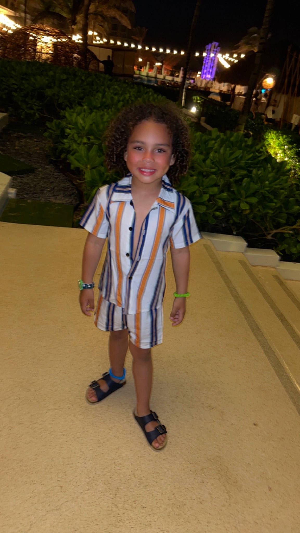 Amiri is registered to the contest to win money with this photo: electric_blue, event, face, flooring, footwear, formal_wear, fun, grass, hair, happy, joy, leisure, person, plant, recreation, sandal, school_uniform, shoe, smile, toddler