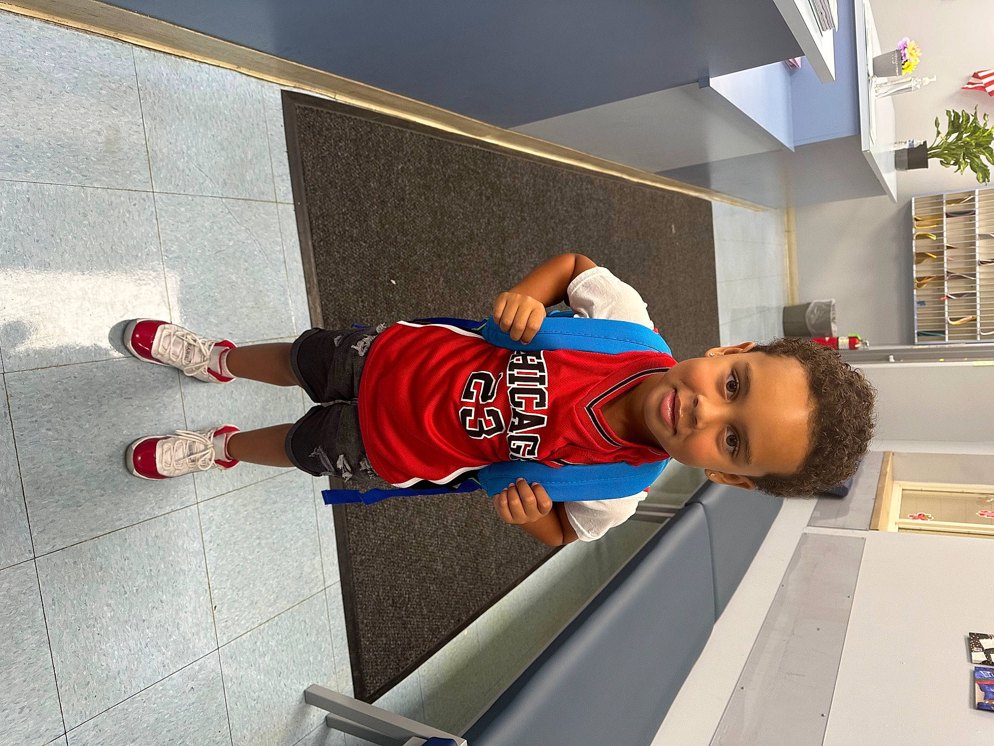 Amiri is registered to the contest to win money with this photo: elbow, electric_blue, flooring, fun, hat, houseplant, human_leg, joy, knee, leisure, person, shorts, sports_uniform, sportswear, t_shirt, thigh, walking_shoe