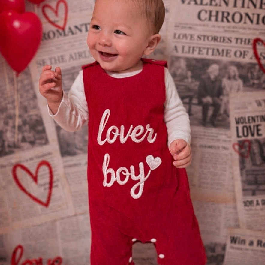 Ezjahramos is registered to the contest to win money with this photo: toddler, child, baby, red_romper, lover_boy, smiling, standing, white_socks, background_newspapers, valentine, heart, red_balloons, indoor, portrait, cute, happy, clothing, baby_boy, studio_photo, infant