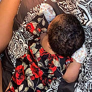 Jelaila joined the competition — help win amazing prizes! baby, infant, floral_clothing, blanket, birthday_candle, cupcake, pattern, sleeping, lying_down, arm, leg, diaper, curly_hair, celebration, bed, soft_lighting, close_up, indoors, child, cute