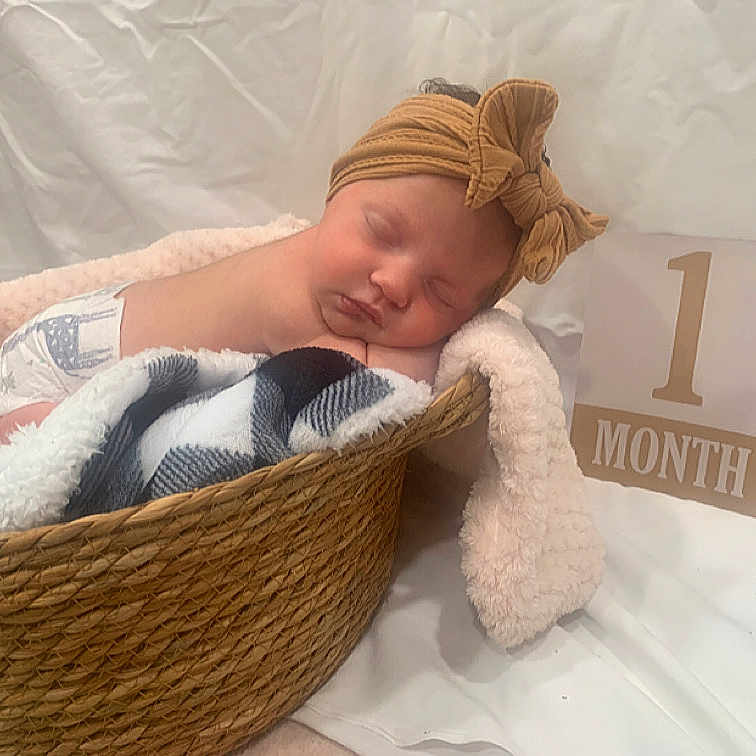 Valerie joined the competition — help win amazing prizes! baby, basket, bed, blanket, bonnet, clothing, cradle, crib, face, furniture, hat, head, homedecor, infantbed, newborn, person, photography, portrait, sleeping, towel