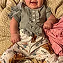 baby, smiling, infant, clothing, patterned_pants, blanket, cute, happy, portrait, child, indoor, sleepwear, comfortable, young, ruffled_top, skin, face, hand, laying_down, expression