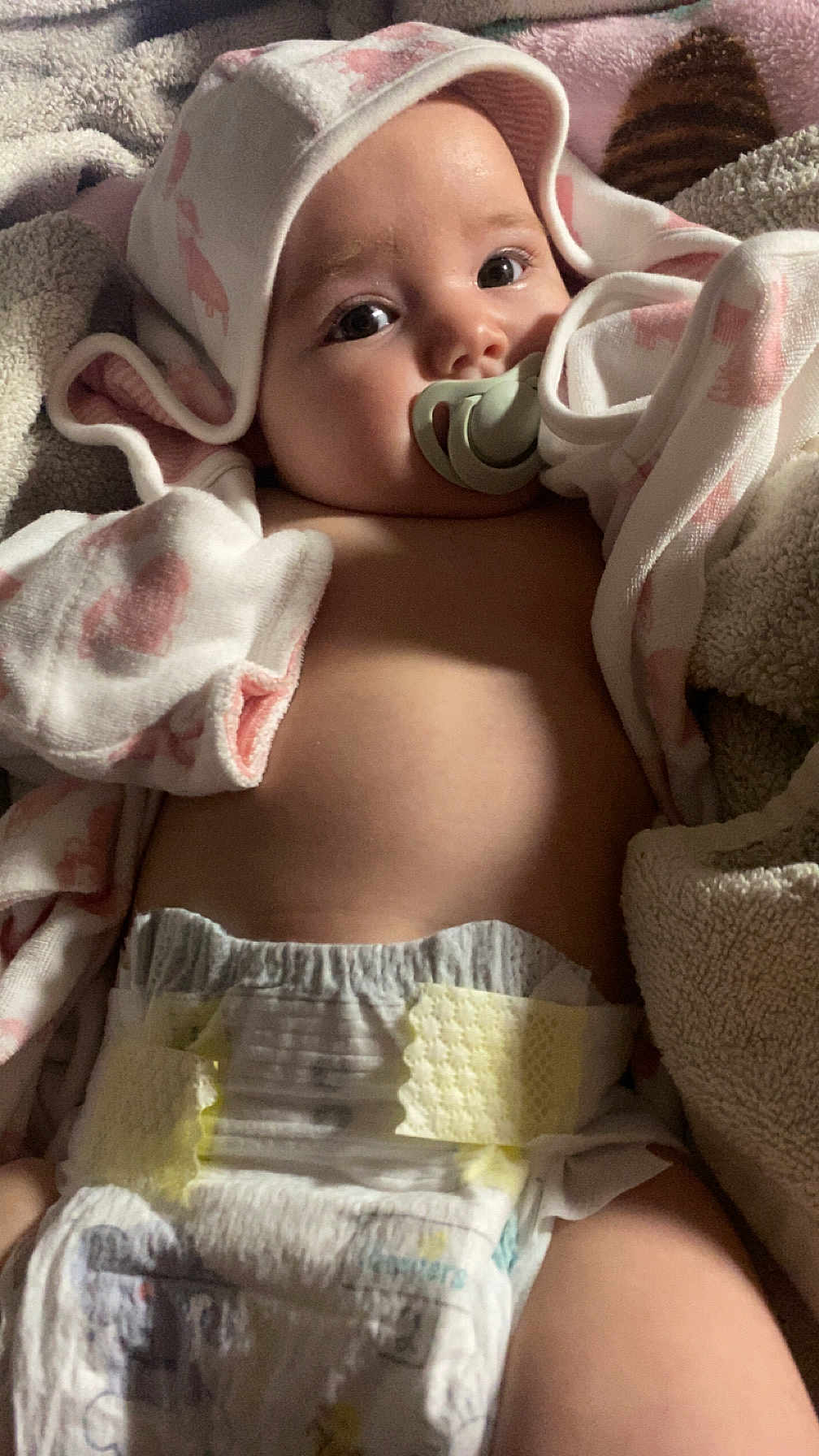 Olivia joined the competition — help win amazing prizes! baby, pacifier, blanket, diaper, hooded_towel, infant, lying_down, cute, soft_texture, sleepy, indoors, closeup, child, newborn, warm, wrapped, comfort, skin, expression, resting