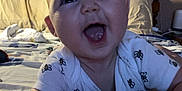 Olivia joined the competition — help win amazing prizes! baby, child, smiling, bed, blanket, onesie, bee_print, indoors, face, headboard, vinyl_record, poster, shelf, wooden_furniture, happy, person, crawling, expression, room, cozy