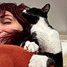Dr. Venkman is registered to the contest to win money with this photo: affection, animal, black_and_white, cat, clinging, close_up, companion, cozy, cute, domestic, face, fur, hair, indoor, orange_clothing, paws, person, pet, relaxed, shoulder