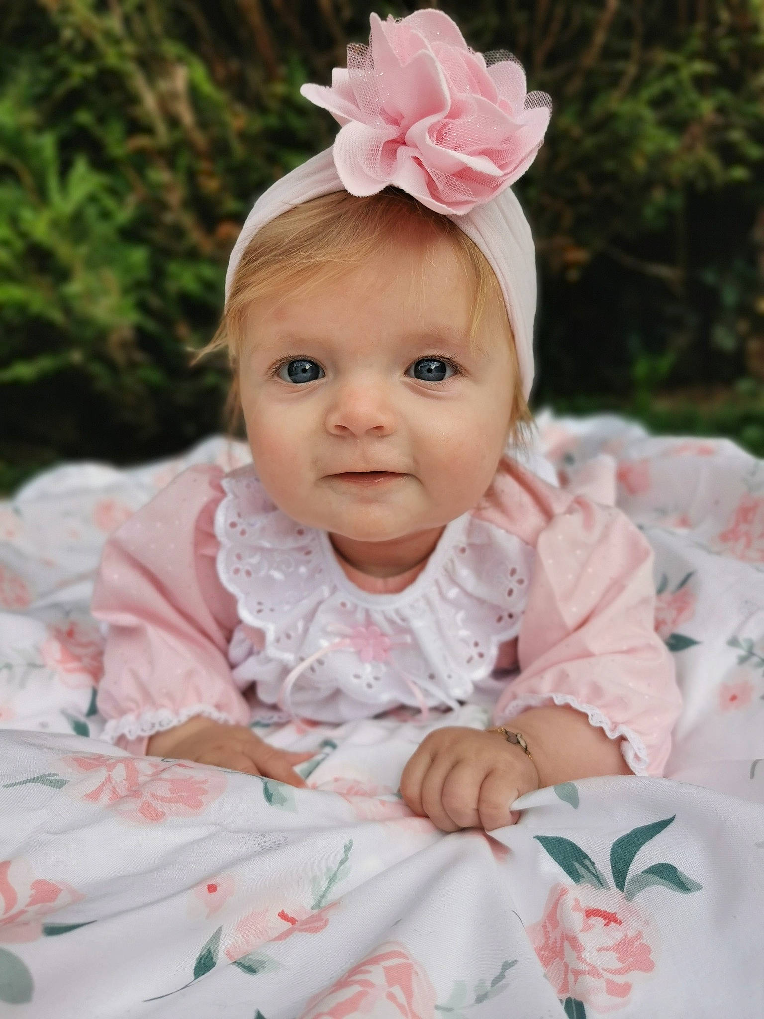 Esmée participe au concours pour gagner de l'argent avec cette photo : baby, baby_toddler_clothing, cheek, dress, eye, flower, grass, happy, head, headpiece, iris, lip, person, petal, pink, plant, skin, sleeve, textile, toddler