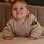 baby, infant, child, smiling, portrait, indoor, couch, pillow, blanket, sweater, patch, hands, face, eyes, drool, photography, warm, cozy, tummy_time, signature